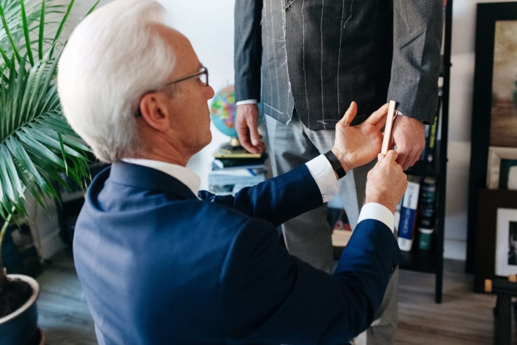 Getting fitted for a custom wedding suit