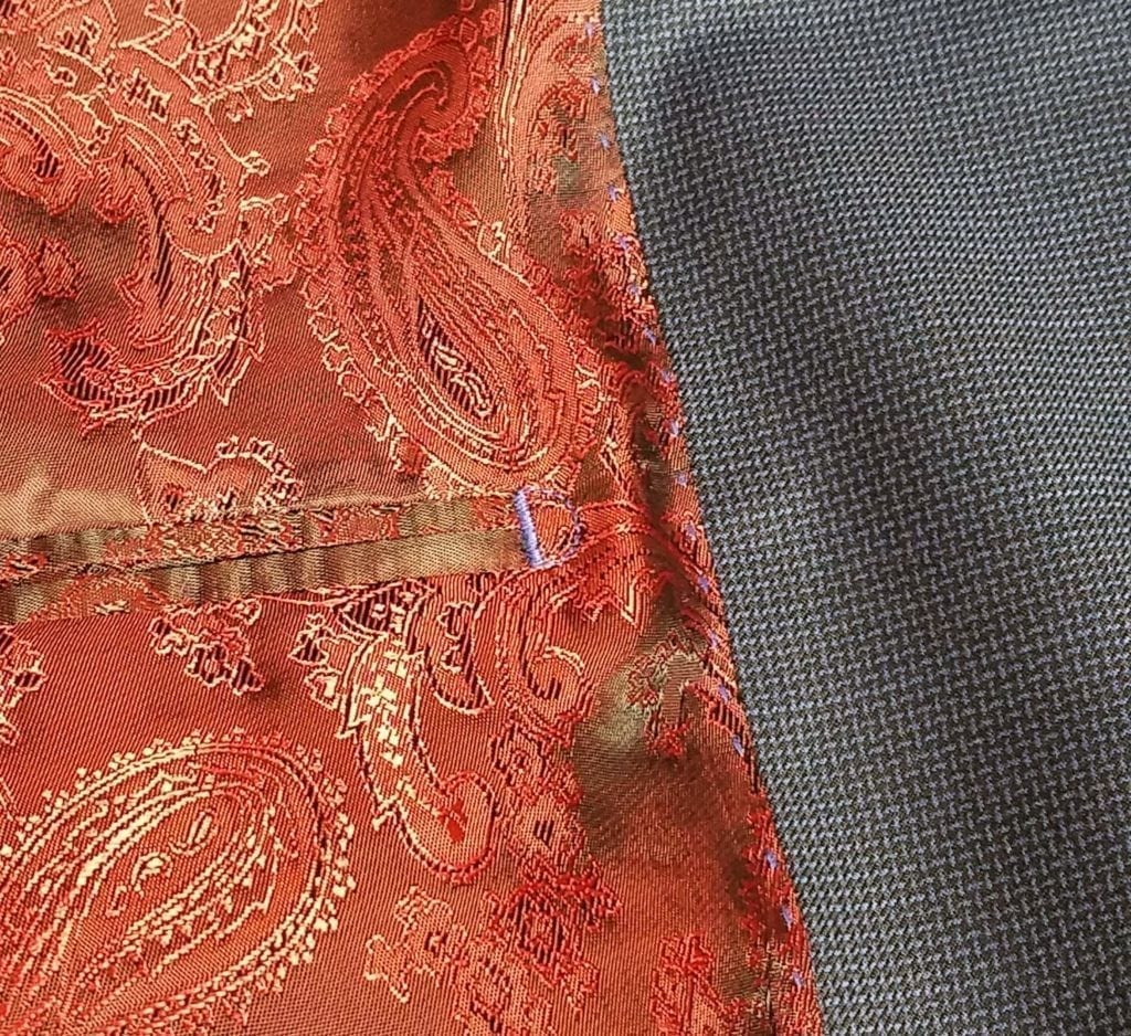 red jacket lining on a nehru wedding suit