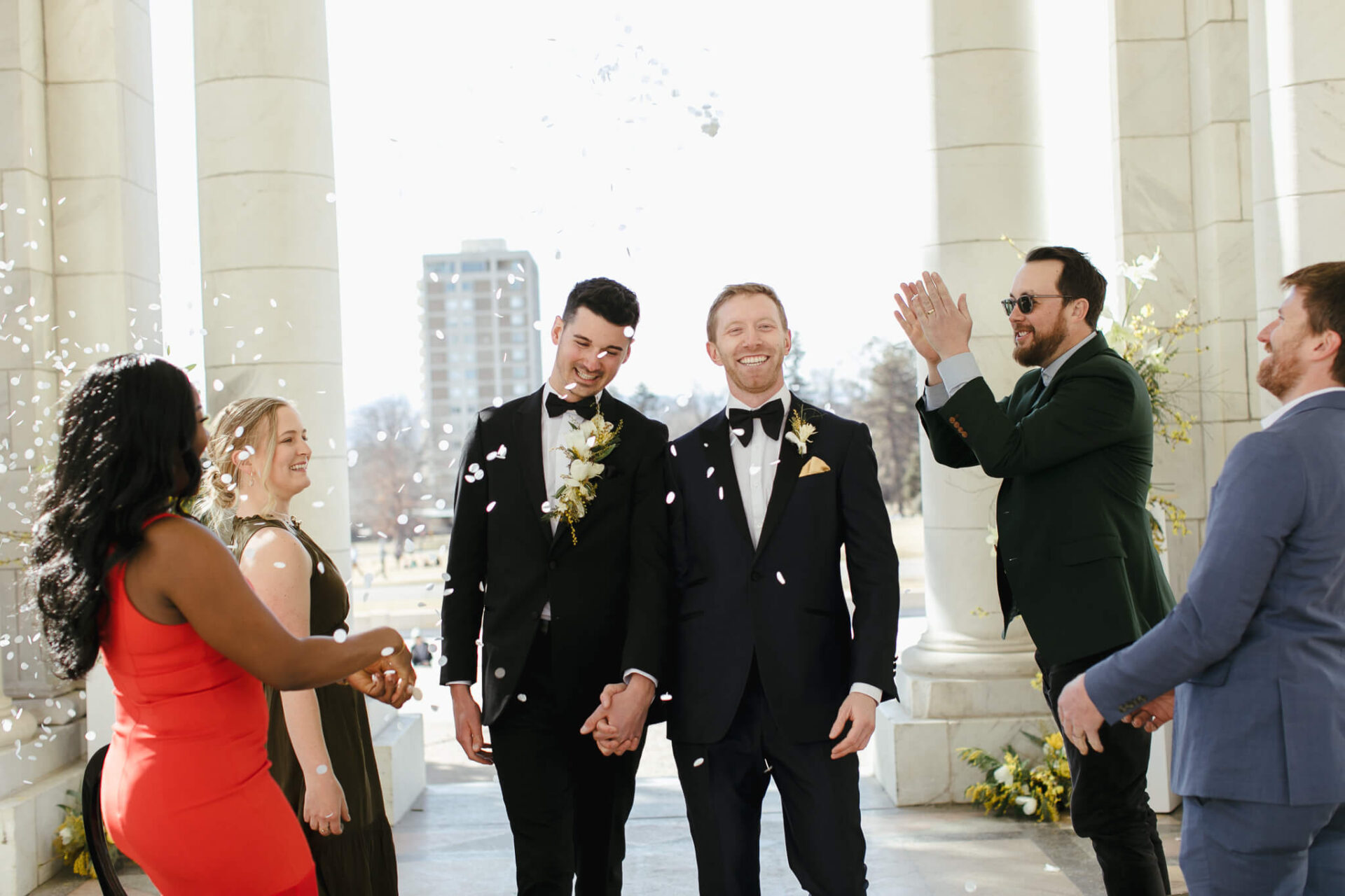 Outside wedding wearing tuxedos